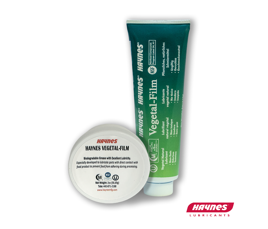 Green tube and white disc of Haynes Vegetal-Film on a white background with a Haynes logo